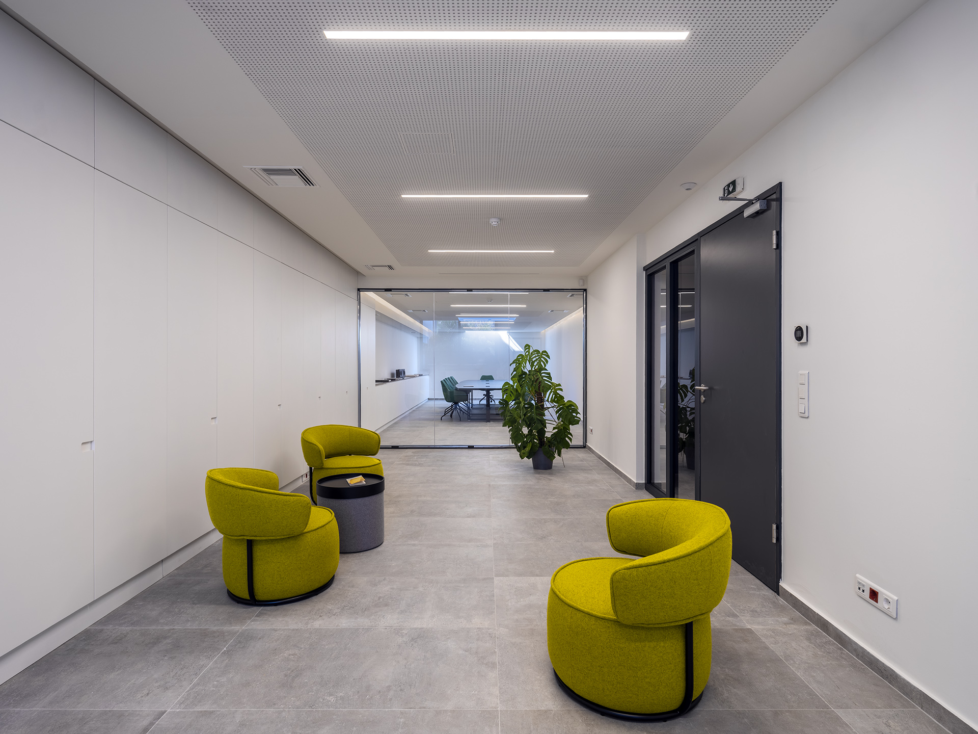 big room with yellow chairs, lights and window